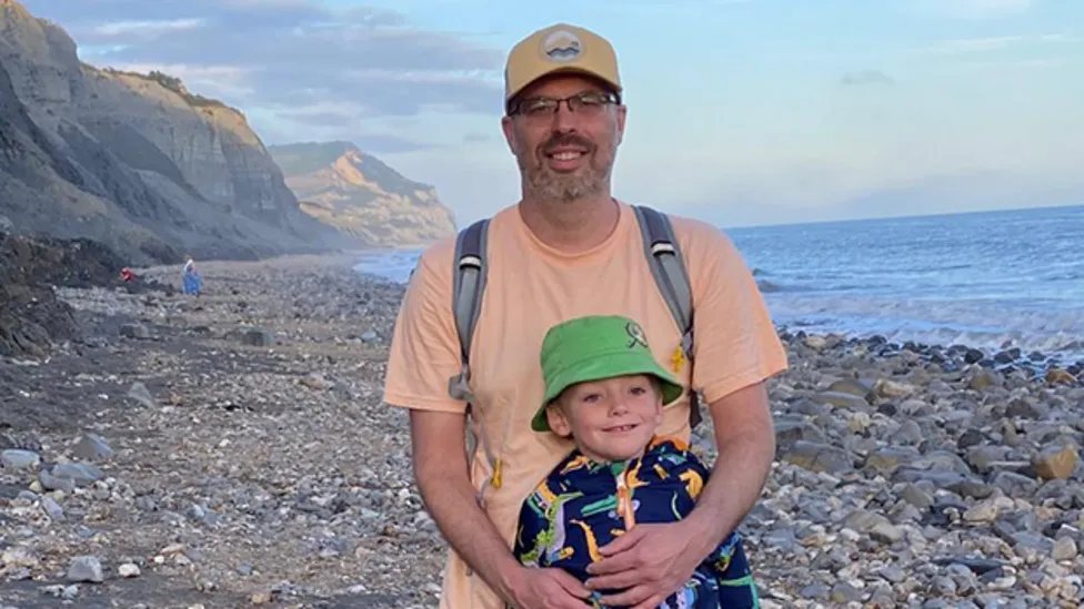 Jonathan Bow and his son on the beach
