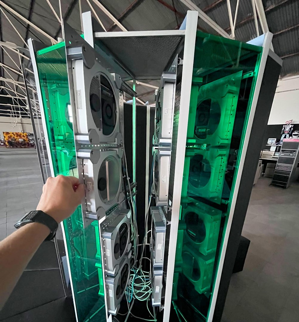 Mac minis mounted vertically in aluminum trays and steel frames to form a natural convection chimney